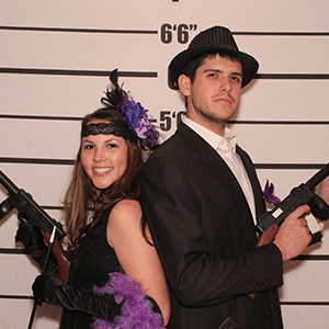 Salt Lake City Murder Mystery party guests pose for mugshots